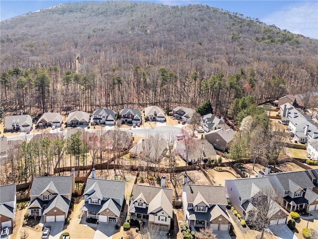 aerial view with a mountain view, a view of trees, and a residential view