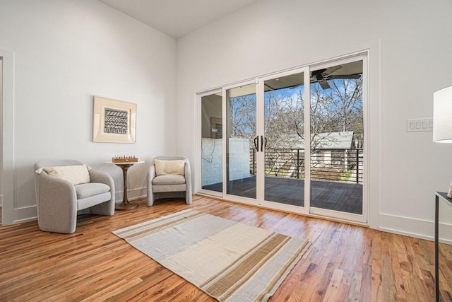 unfurnished room with ceiling fan, wood finished floors, and baseboards