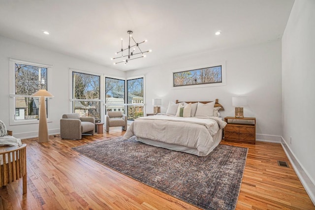 bedroom featuring a chandelier, recessed lighting, visible vents, baseboards, and light wood-type flooring