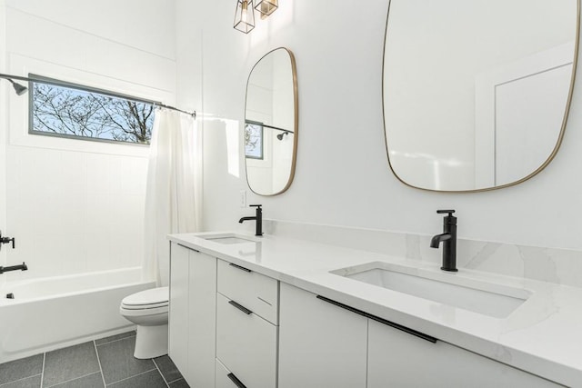 full bathroom with shower / tub combo with curtain, a sink, toilet, and tile patterned floors