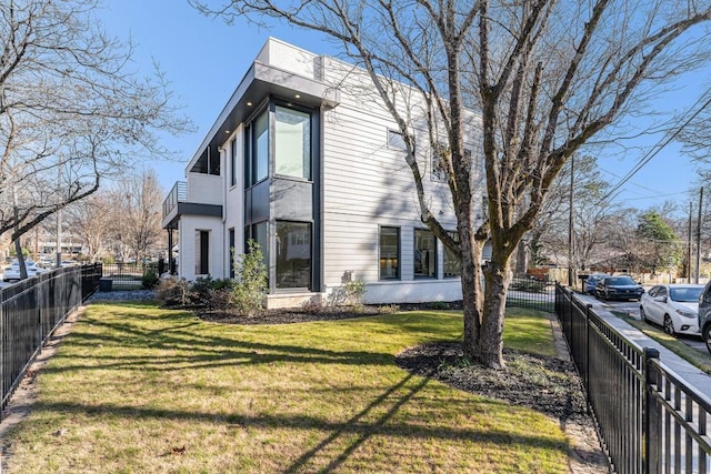 view of home's exterior with a yard and fence