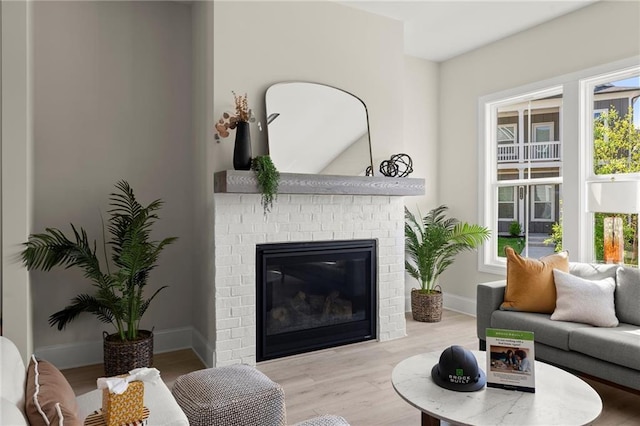 1941 Quarry Park Pl NW, Atlanta, GA 30318 - living room featuring a brick fireplace, wood finished floors, and baseboards