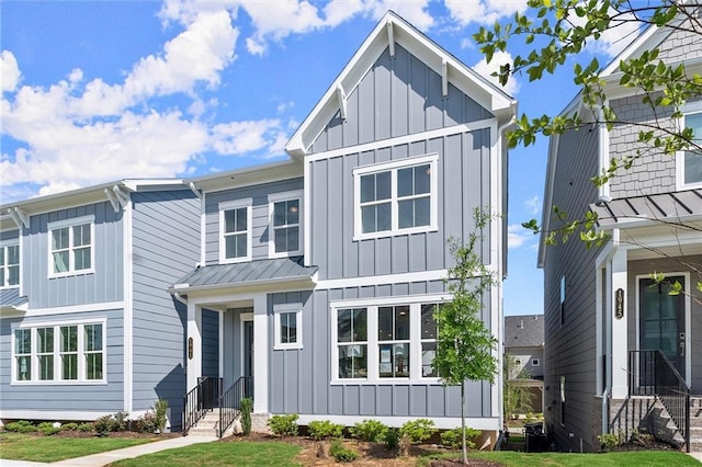 1941 Quarry Park Pl NW, Atlanta, GA 30318 - view of front of home with board and batten siding, a standing seam roof, and entry steps