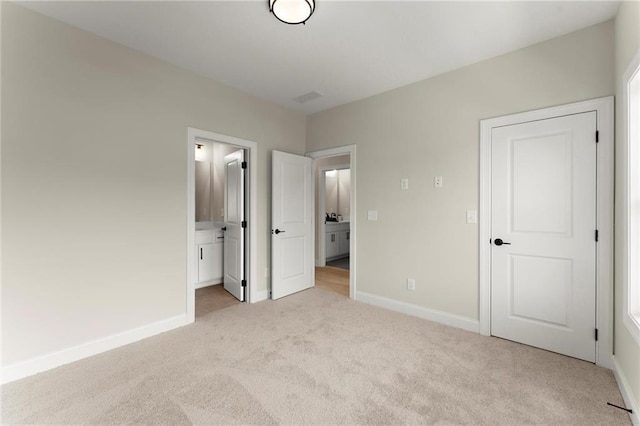 1941 Quarry Park Pl NW, Atlanta, GA 30318 - unfurnished bedroom with light carpet, baseboards, and ensuite bathroom