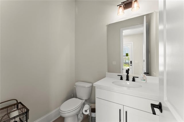 1941 Quarry Park Pl NW, Atlanta, GA 30318 - bathroom with toilet, vanity, and baseboards