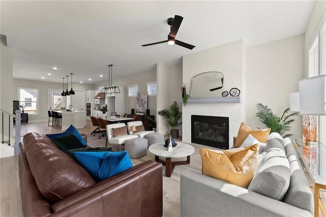 1941 Quarry Park Pl NW, Atlanta, GA 30318 - living area featuring light wood finished floors, ceiling fan, a brick fireplace, and recessed lighting