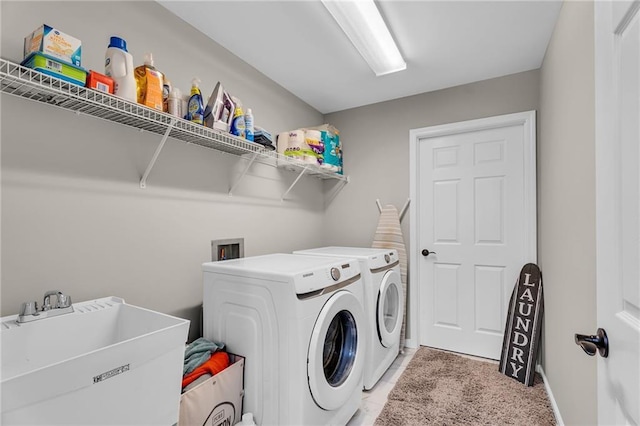 washroom with separate washer and dryer, sink, and tile patterned flooring