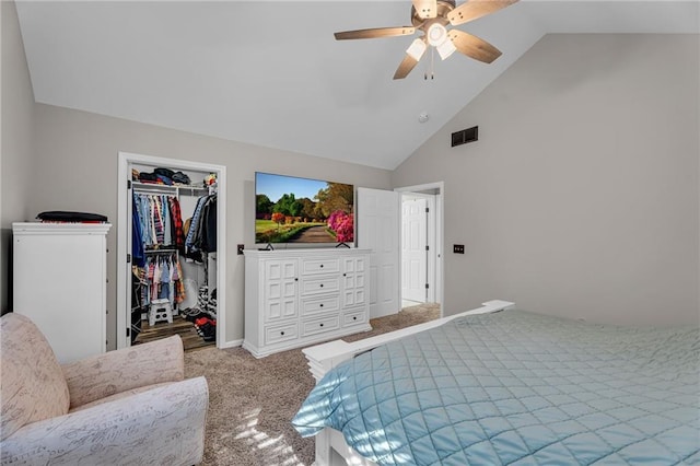 carpeted bedroom featuring ceiling fan, high vaulted ceiling, a closet, and a walk in closet