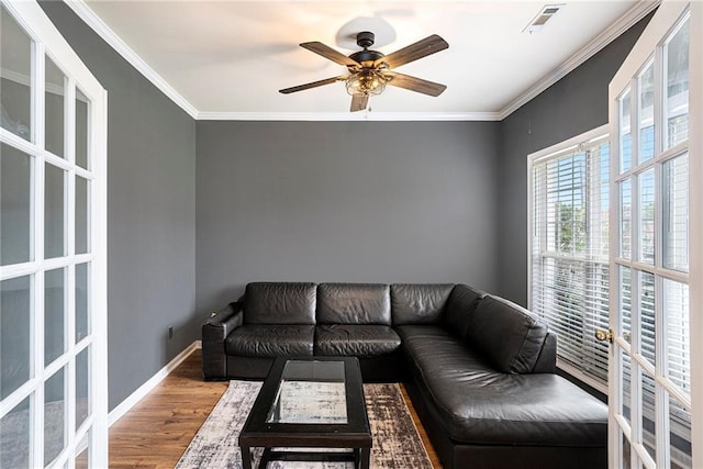 living room with hardwood / wood-style floors, french doors, ceiling fan, and crown molding