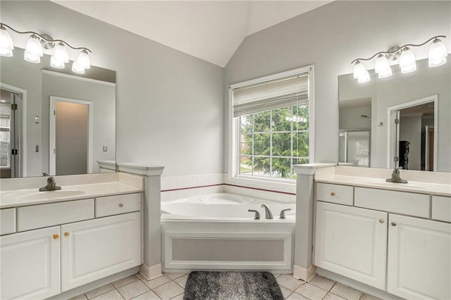 bathroom featuring tile patterned floors, separate shower and tub, vanity, and vaulted ceiling