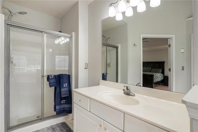 bathroom featuring tile patterned flooring, vanity, and a shower with shower door