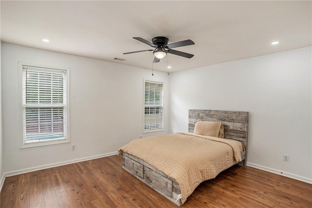 bedroom with ceiling fan and hardwood / wood-style flooring