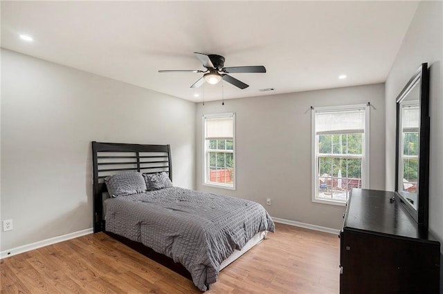 bedroom with light hardwood / wood-style floors and ceiling fan