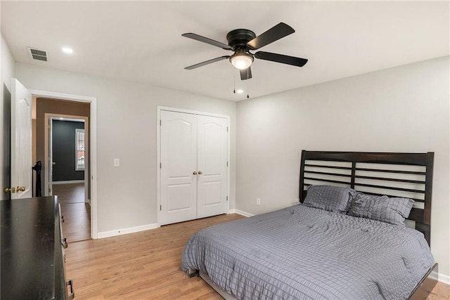 bedroom featuring ceiling fan, a closet, and light hardwood / wood-style floors