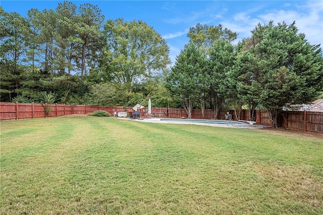 view of yard with a fenced in pool