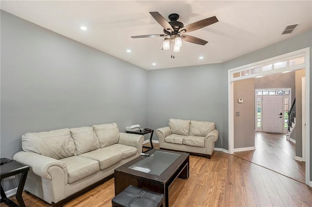 living room featuring light hardwood / wood-style floors and ceiling fan