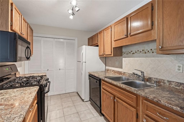 kitchen with black appliances, a sink, backsplash, and brown cabinets