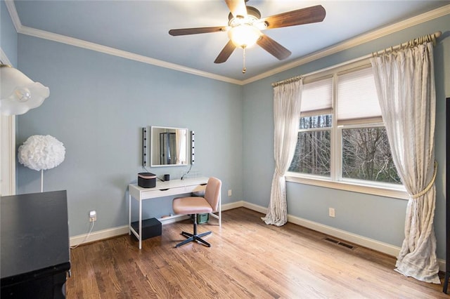 office area featuring baseboards, crown molding, visible vents, and wood finished floors