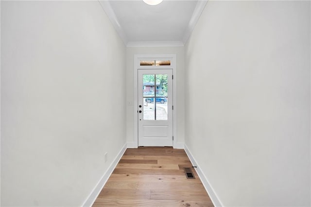 1664 Crestridge Dr SE, Marietta, GA 30067 - doorway featuring crown molding, light wood-type flooring, and baseboards
