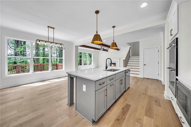 1664 Crestridge Dr SE, Marietta, GA 30067 - kitchen featuring gray cabinetry, a sink, light wood finished floors, recessed lighting, and pendant lighting
