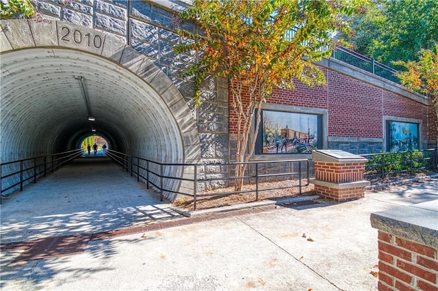 exterior space with concrete driveway and brick siding