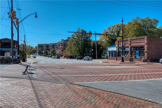 view of street with street lights, traffic lights, and sidewalks