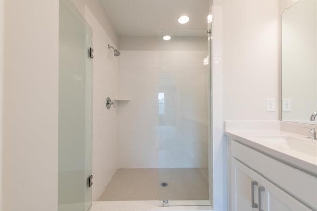 full bathroom with a shower stall and vanity