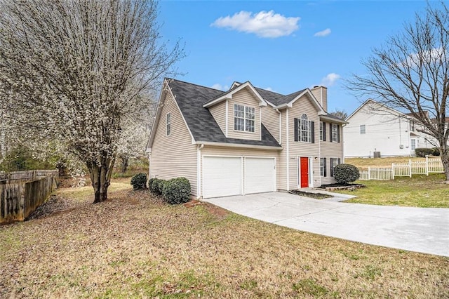 traditional-style home featuring a shingled roof, a front lawn, fence, a chimney, and driveway