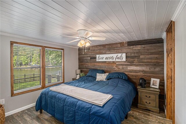 370 David Williams Rd, Sparta, GA 31087 - bedroom with wooden walls, a ceiling fan, baseboards, wood finished floors, and ornamental molding