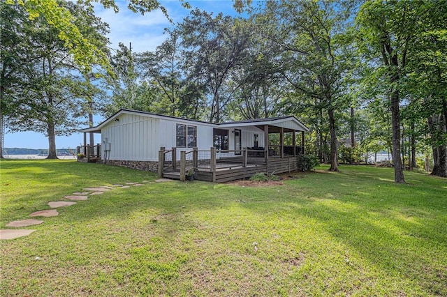 370 David Williams Rd, Sparta, GA 31087 - back of house featuring a lawn, board and batten siding, and a deck