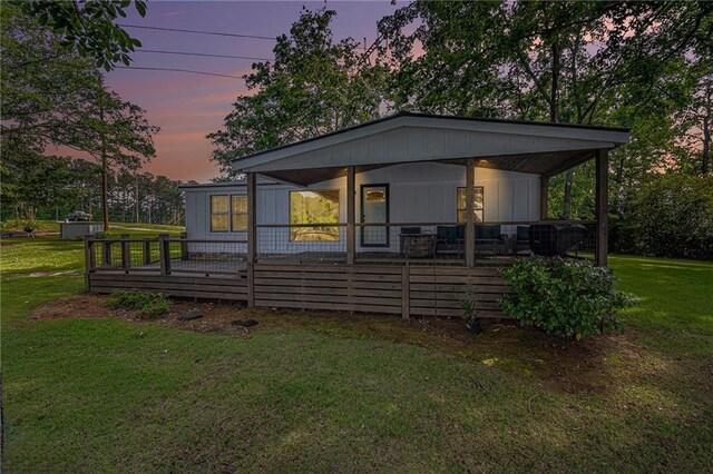 370 David Williams Rd, Sparta, GA 31087 - back of house at dusk with a yard, board and batten siding, and a porch