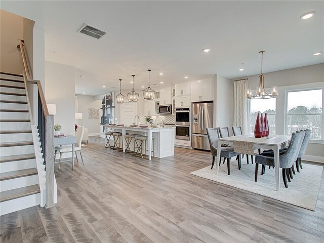 dining room featuring light hardwood / wood-style floors and a chandelier