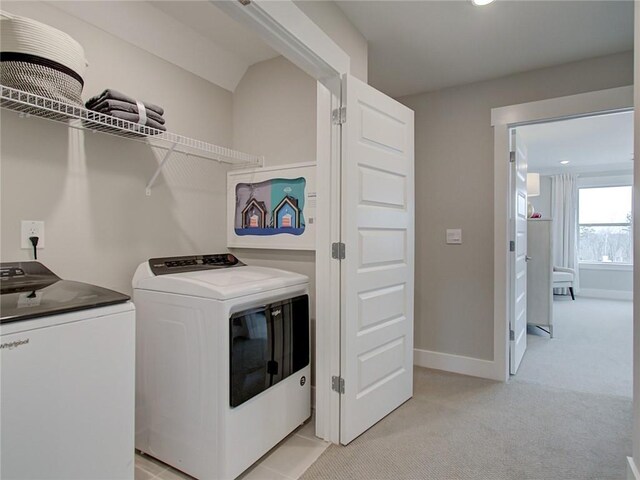 laundry area featuring light colored carpet and independent washer and dryer