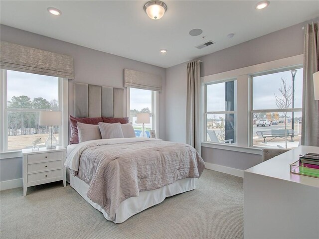 bedroom featuring light carpet