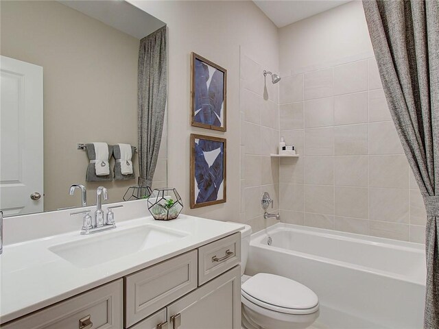 full bathroom with shower / bath combination with curtain, toilet, and vanity