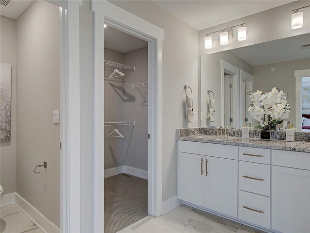 bathroom with tile patterned flooring and vanity