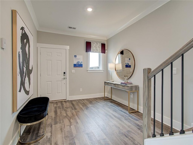 entryway with hardwood / wood-style flooring and ornamental molding