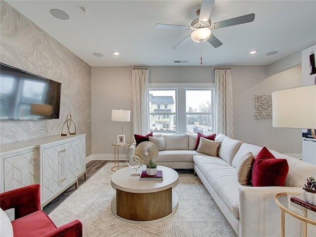 living room featuring ceiling fan and hardwood / wood-style flooring