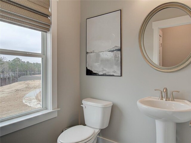 bathroom with a wealth of natural light and toilet