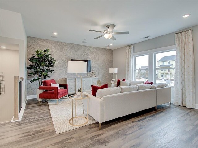 living room featuring ceiling fan and wood-type flooring