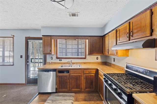 kitchen featuring dark hardwood / wood-style flooring, sink, and appliances with stainless steel finishes