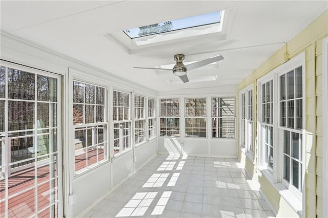 unfurnished sunroom featuring a skylight and a ceiling fan