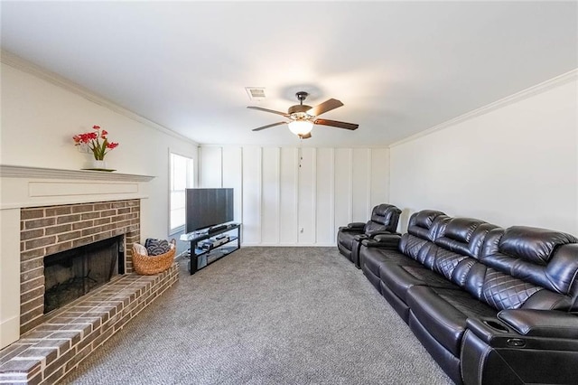 living room featuring a brick fireplace, ceiling fan, ornamental molding, and carpet flooring