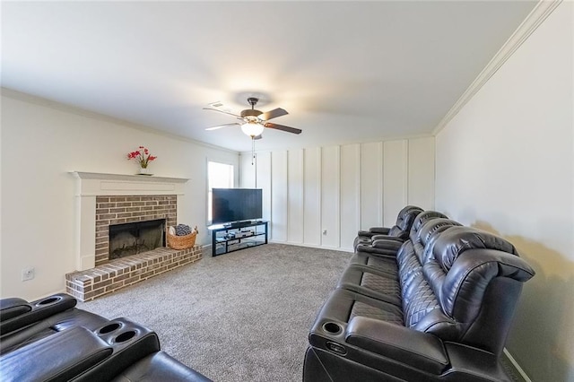 carpeted living room featuring a brick fireplace, ceiling fan, and ornamental molding