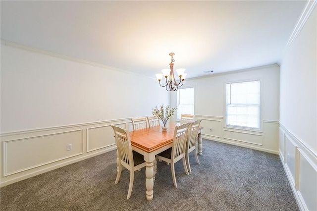 carpeted dining space with a chandelier and crown molding