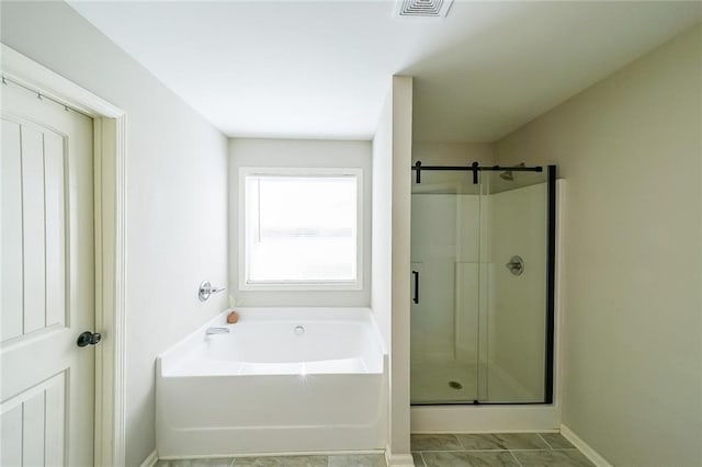 bathroom featuring tile patterned floors and shower with separate bathtub