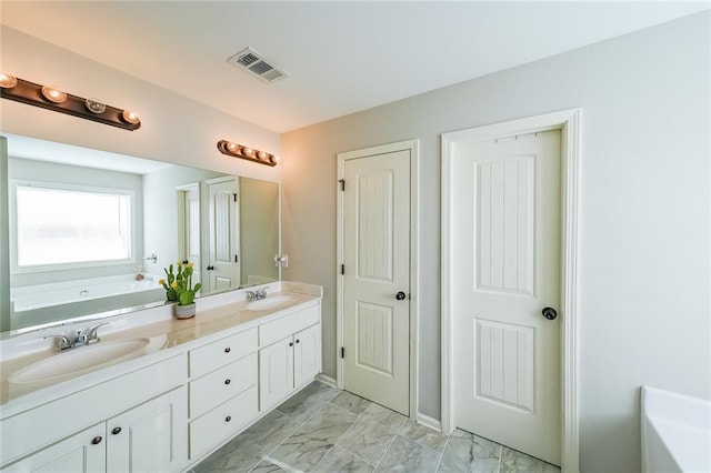 bathroom featuring vanity and a washtub