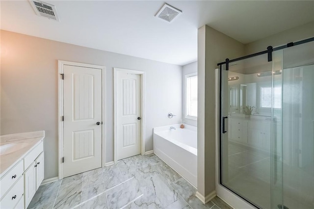 bathroom with vanity and shower with separate bathtub