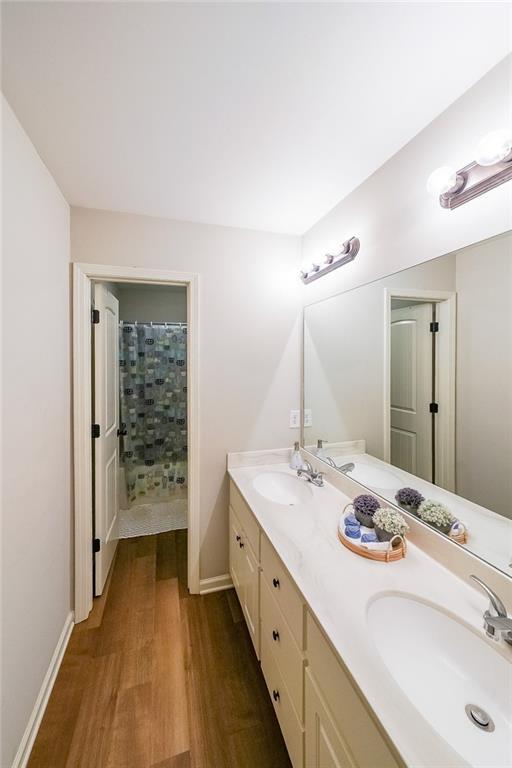 bathroom featuring vanity, hardwood / wood-style flooring, and a shower with curtain