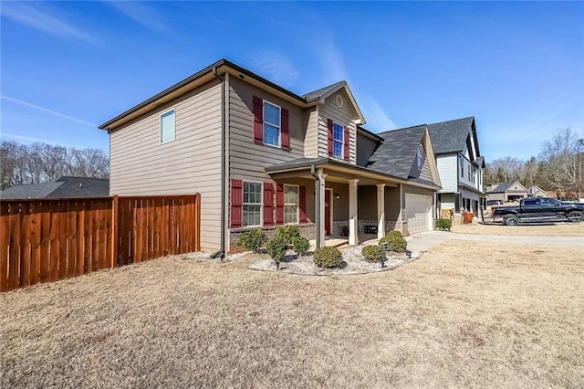 view of property exterior featuring covered porch and a garage